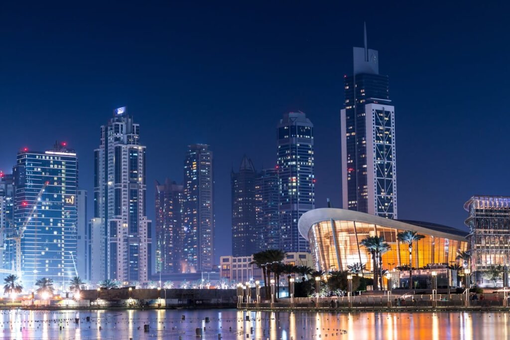 pexels-photo-442579 Stunning view of Dubai's illuminated skyline with modern skyscrapers reflecting on water at night.
